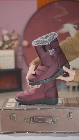 Red SnowLuxe waterproof snow boots with fur lining for reliable winter protection.