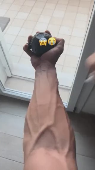 Hand grip strengthening exercise using GripFlex trainer with resistance massage ball.