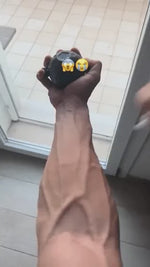Hand grip strengthening exercise using GripFlex trainer with resistance massage ball.