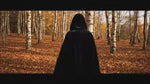 Black velvet Spookora cape in wooded forest setting creating spooky Halloween mood.