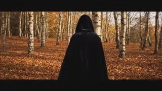 Black velvet Spookora cape in wooded forest setting creating spooky Halloween mood.