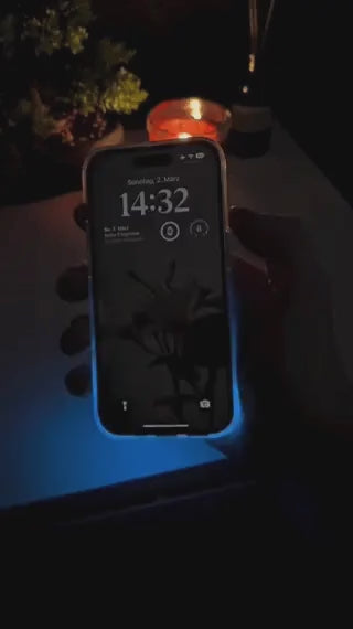 GlowSand phone case glowing in dark with LED-inspired luminous liquid effect.