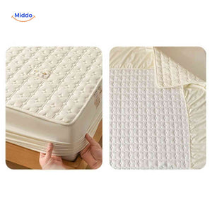 Quilted mattress protector with elastic corners for complete bed protection.