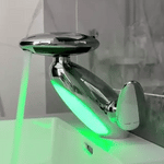 Chrome pull-out LED bathroom faucet with green mood light installed on a countertop basin.