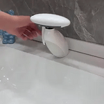 White pull-out LED bathroom faucet installed on a countertop vanity in a modern bathroom.