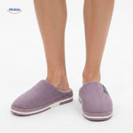 Man wearing purple non-slip cotton slippers, front view model.