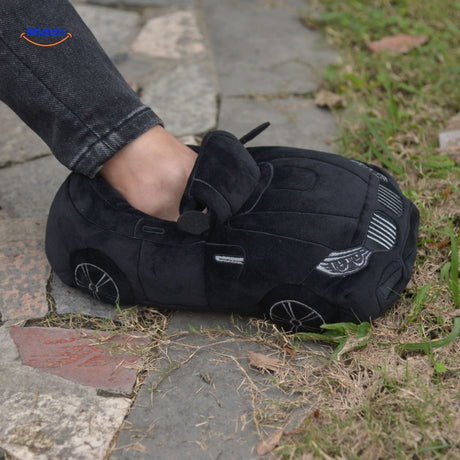 Black car slippers offering cozy plush coverage for relaxed home wear.