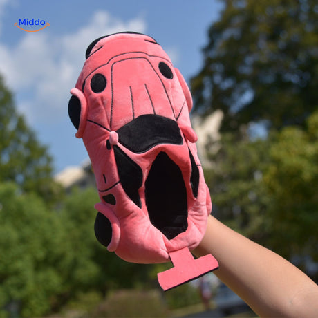 Pink racecar slippers offering plush comfort for relaxing at home.