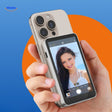 MagnoScreen rear display with live selfie preview on smartphone.