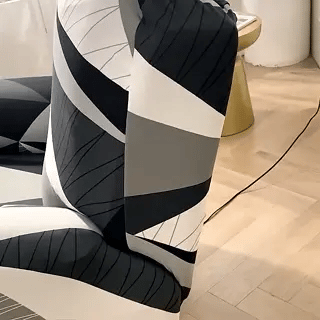 Reclinex recliner cover fitted on chair in black white gray pattern.