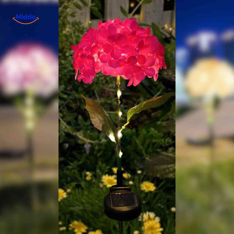 Red hydrangea solar lantern creating warm ambiance for garden pathways.
