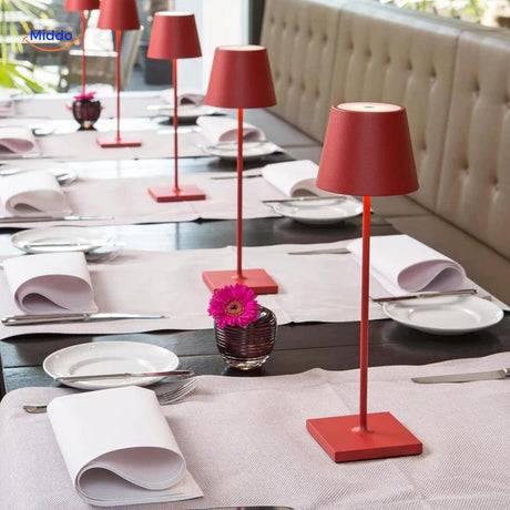 Multiple red dimmable LED lamps grouped together on a table.