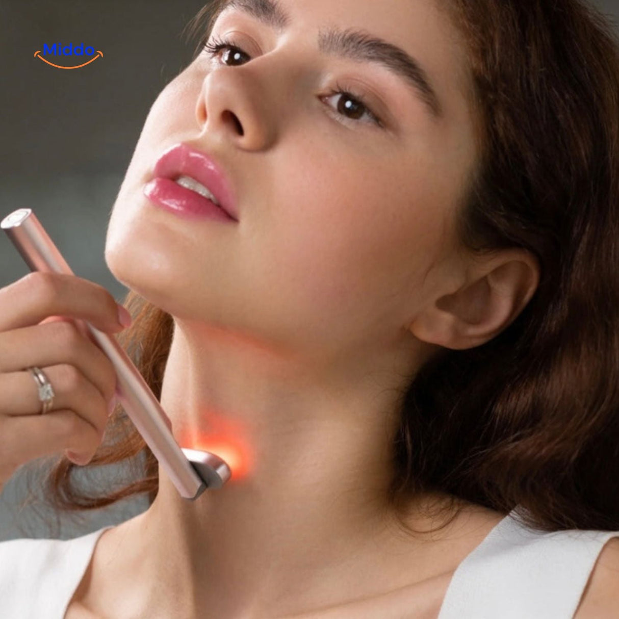 Red light therapy EMS pen in use on face during at-home skincare treatment.