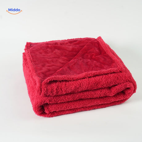 Red waterproof pet blanket with cozy fleece texture for dogs.