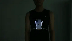 Reflective running vest phone holder designed for night visibility and safety during evening runs.