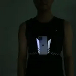 Reflective running vest phone holder designed for night visibility and safety during evening runs.