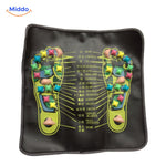 Feet on the ReflexoStep acupressure mat during health stimulation session.