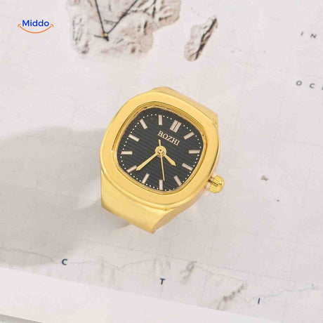 Gold ring watch with black square dial.