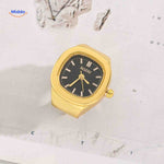 Gold ring watch with black square dial.