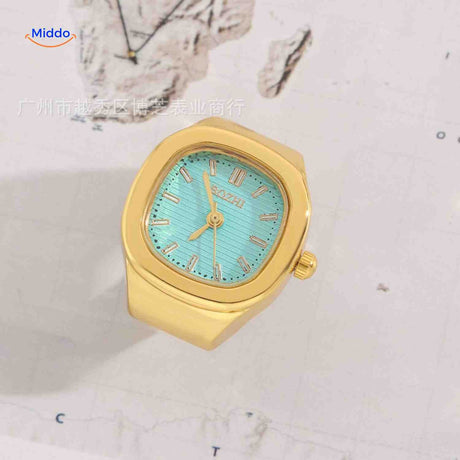 Gold ring watch with mint green square dial.