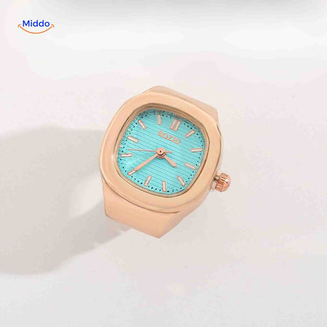 Rose gold ring watch with mint green square dial.