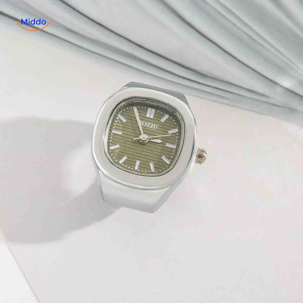 Silver ring watch with green square dial.
