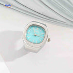 Silver ring watch with mint green square dial.
