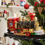 ChristmasRail round train set surrounded by traditional holiday decoration pieces.