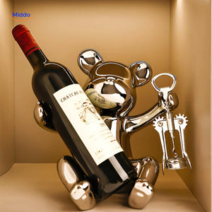 Rustic wooden wine bottle holder shaped like a bear, displayed as a decorative showpiece on a tabletop.