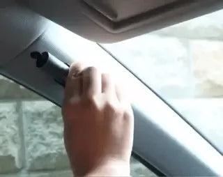 SafeKey Pro escape tool being used to break car window in emergency situation.