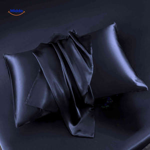 Dark blue satin pillowcase flat lay with smooth texture.