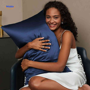 Dark blue satin pillowcase for skin and hair protection.