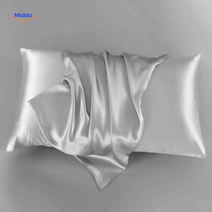 Grayish blue satin pillowcase flat lay elegant neutral tone.