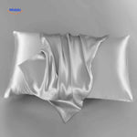 Grayish blue satin pillowcase flat lay elegant neutral tone.
