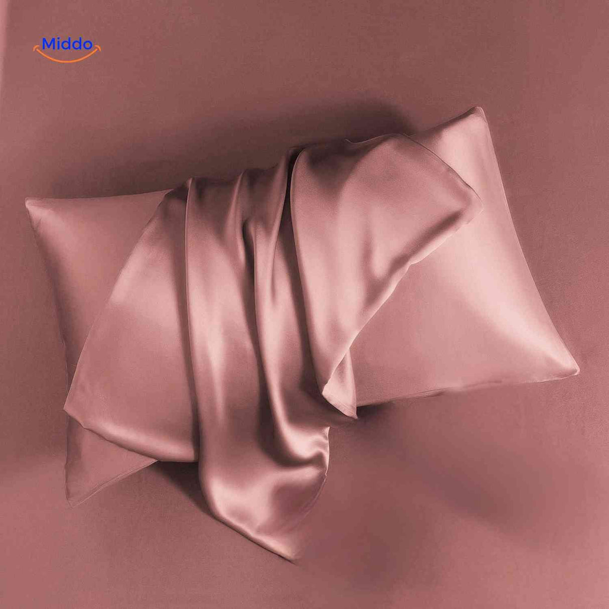 Pink satin pillowcase flat lay soft and luxurious feel.