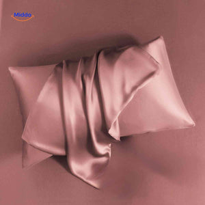 Pink satin pillowcase flat lay soft and luxurious feel.