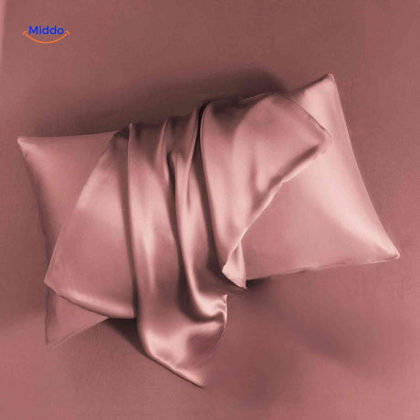 Pink satin pillowcase flat lay soft and luxurious feel.