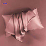 Pink satin pillowcase flat lay soft and luxurious feel.