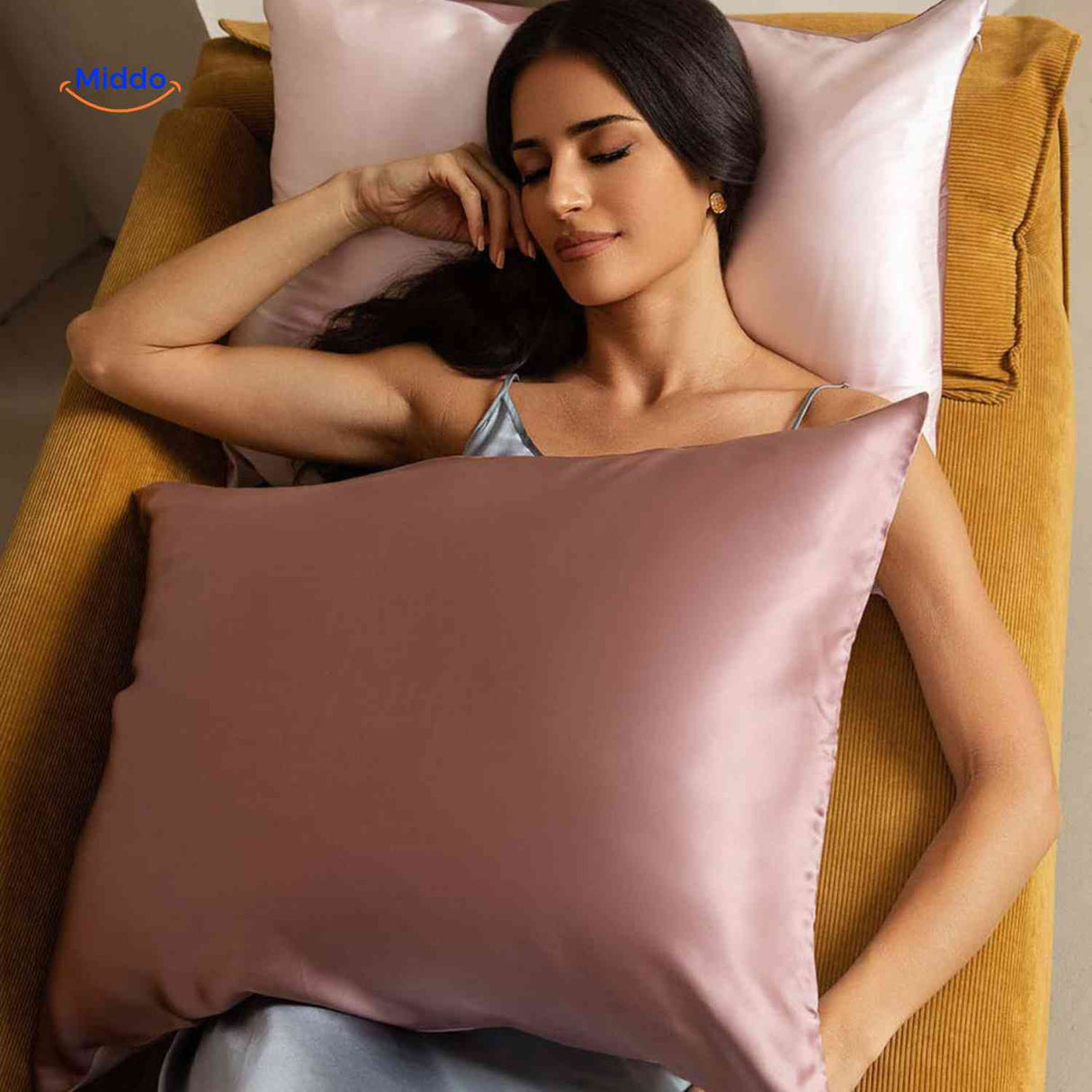 Pink satin pillowcase styled for anti-aging hair benefits.