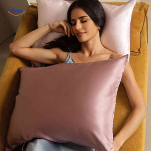 Pink satin pillowcase styled for anti-aging hair benefits.