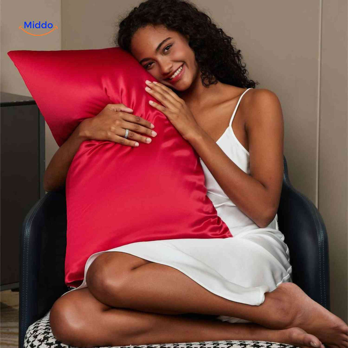 Red satin pillowcase on pillow for nighttime hair care.