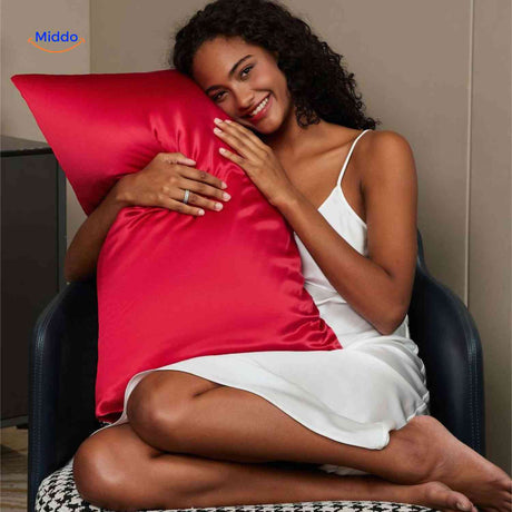 Red satin pillowcase on pillow for nighttime hair care.