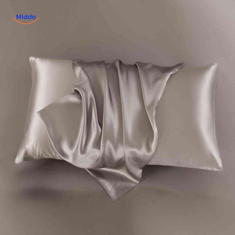Taupe satin pillowcase displayed flat neutral elegant tone.