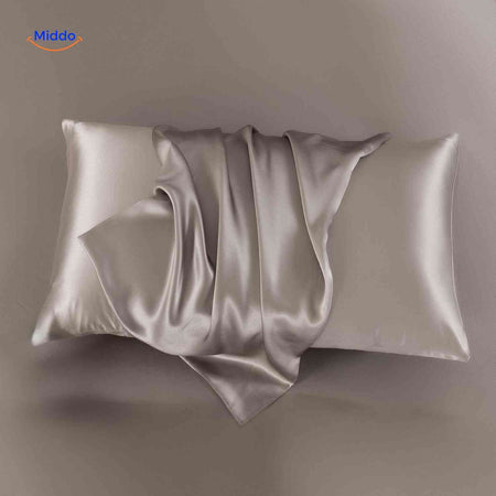 Taupe satin pillowcase displayed flat neutral elegant tone.