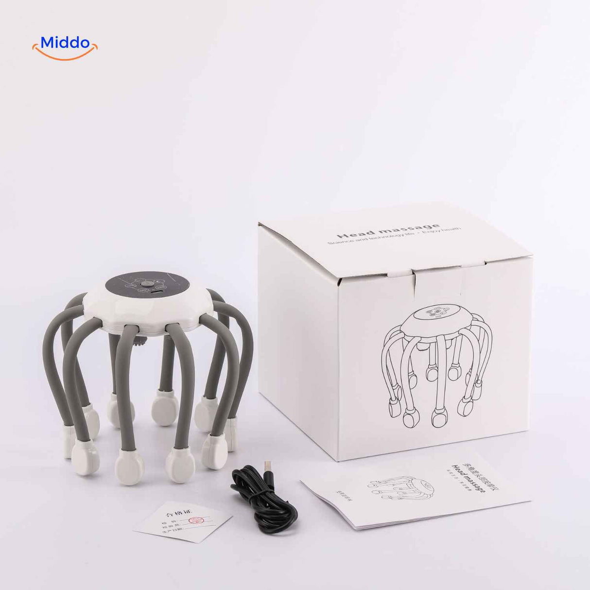 Electric scalp massager displayed with its retail box and USB charging cable