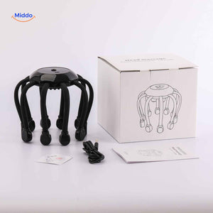 Electric scalp head massager next to USB charger showing charging port and cable connection