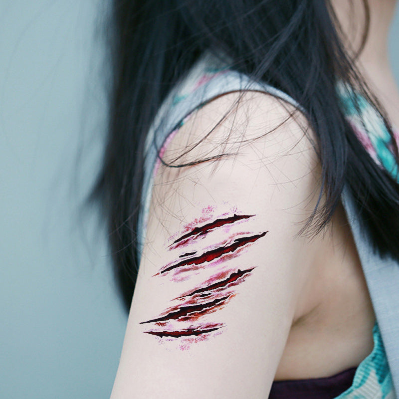 Scary scratch wound temporary tattoo design applied to woman's arm.
