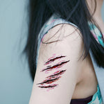 Scary scratch wound temporary tattoo design applied to woman's arm.