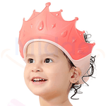 Young child wearing a pink ShampooCrown shower cap during bath time.