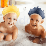 Two children wearing colorful ShampooCrown shower shields while bathing comfortably.